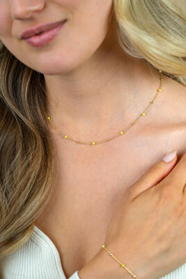 ZINZI gold plated zilveren fantasie ketting met 13 geelgroene donuts en glanzende bolletjes 42-45cm ZIC2508